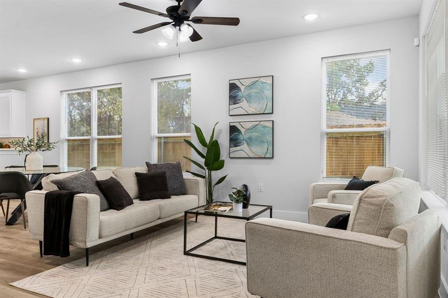 Living room featuring light hardwood / wood-style floors, a wealth of natural light, and ceiling fan