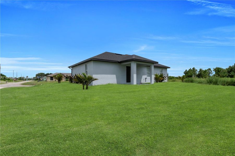 Front exterior of a new home in , Lehigh Acres, FL, highlighting curb appeal (Image 15).