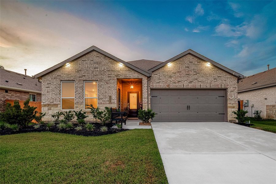 Welcoming single-story brick exterior with well-maintained front lawn and attached garage. Welcoming single-story brick exterior with well-maintained front lawn and attached garage.