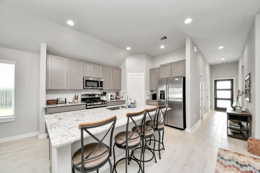 Rich cabinetry and an ergonomic work triangle blend modern functionality with effortless culinary style.