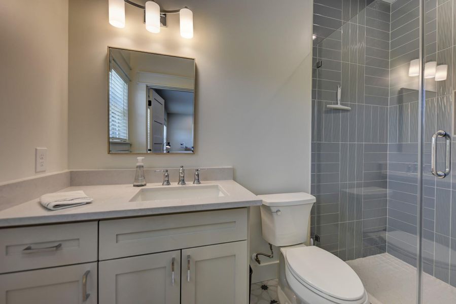 A well-appointed bathroom with a spacious vanity and a contemporary glass-enclosed shower.