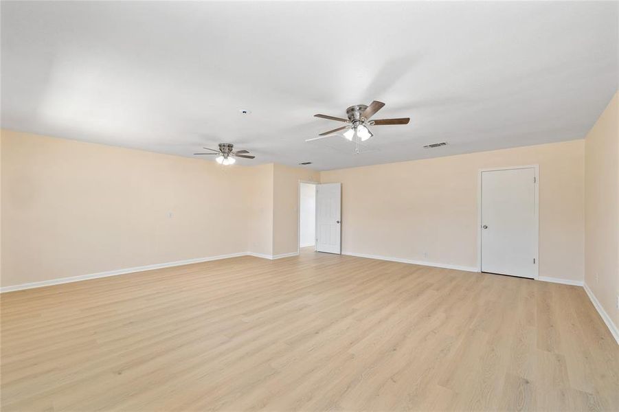 Spare room featuring light wood-type flooring and a ceiling fan