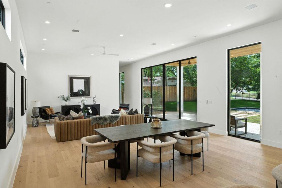Dining space with recessed lighting, healthy amount of natural light, light wood-style flooring, and a ceiling fan Dining space with recessed lighting, healthy amount of natural light, light wood-style flooring, and a ceiling fan