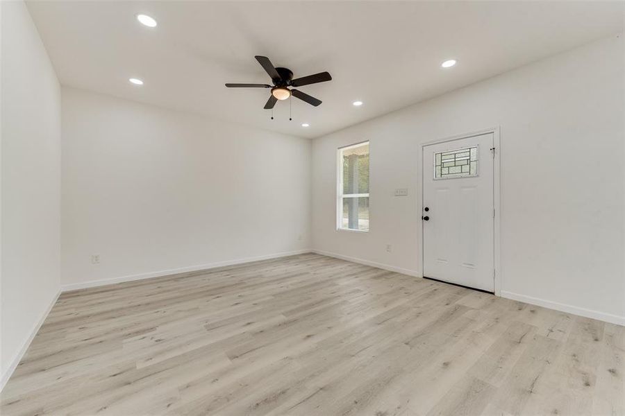 Entrance foyer featuring ceiling fan and light hardwood / wood-style flooring