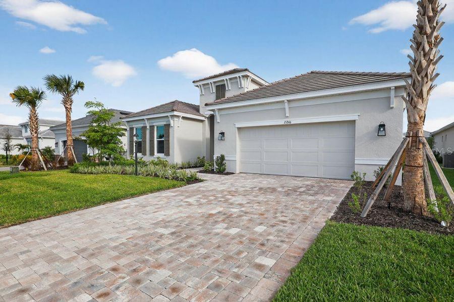 Front exterior of a new home in Esplanade at Azario Lakewood Ranch, Bradenton, FL, highlighting curb appeal (Image 19). Front exterior of a new home in Esplanade at Azario Lakewood Ranch, Bradenton, FL, highlighting curb appeal (Image 19).