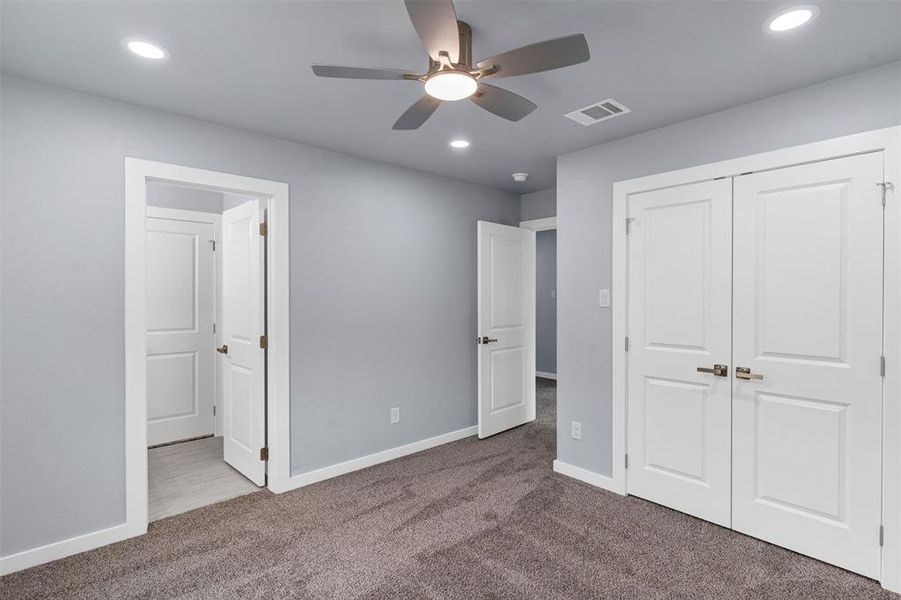 Unfurnished bedroom with carpet, recessed lighting, a ceiling fan, and a closet