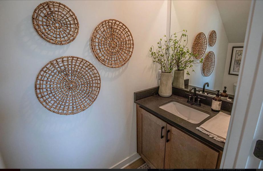 Vanity featuring an integrated rectangular sink, matte black faucet, and dark countertop