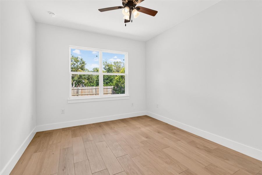 Bedroom #2 without virtual staging facing the back of the home