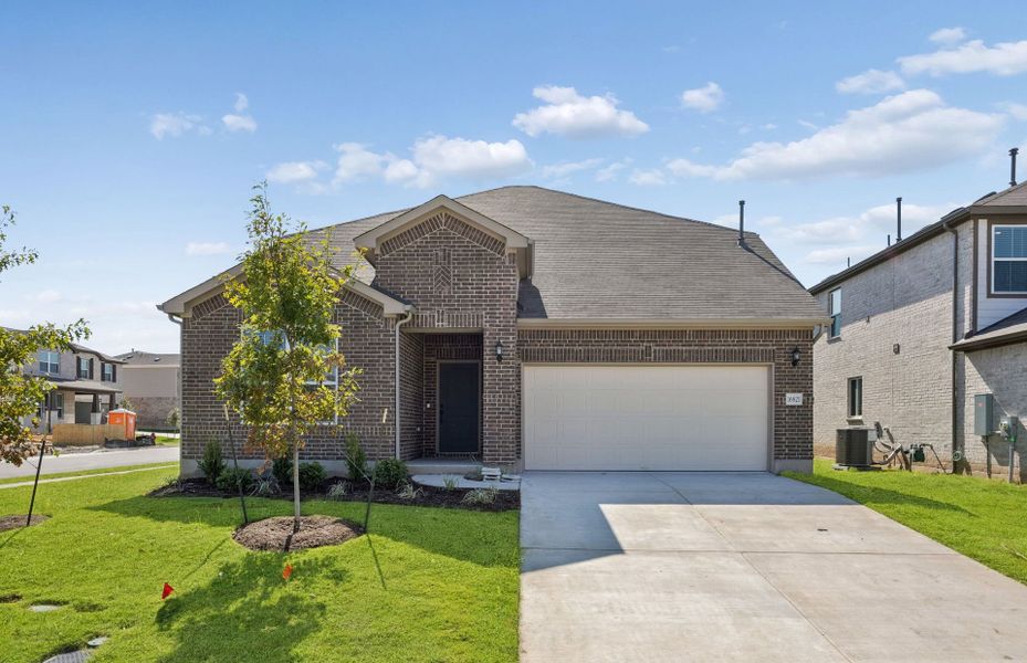 Front exterior of a new home in Lagos, Manor, TX, highlighting curb appeal (Image 20).