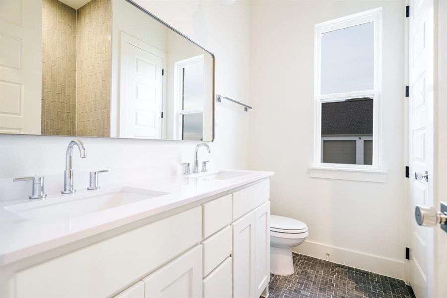 Bathroom with tile patterned flooring, vanity, and toilet