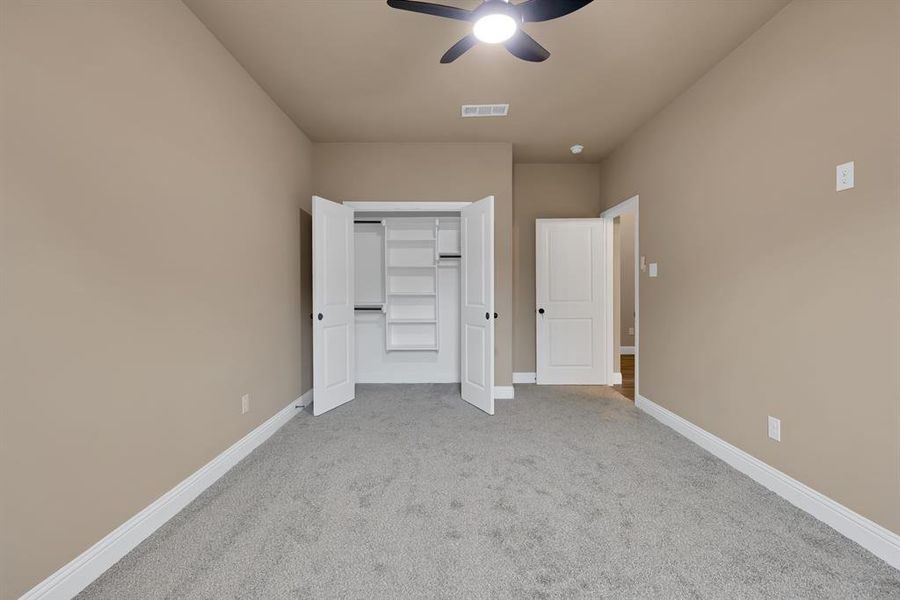 Unfurnished bedroom featuring baseboards, visible vents, carpet, and a closet Unfurnished bedroom featuring baseboards, visible vents, carpet, and a closet