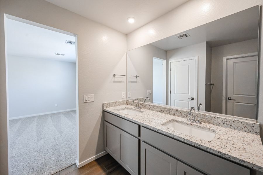 A bathroom with a large mirror.