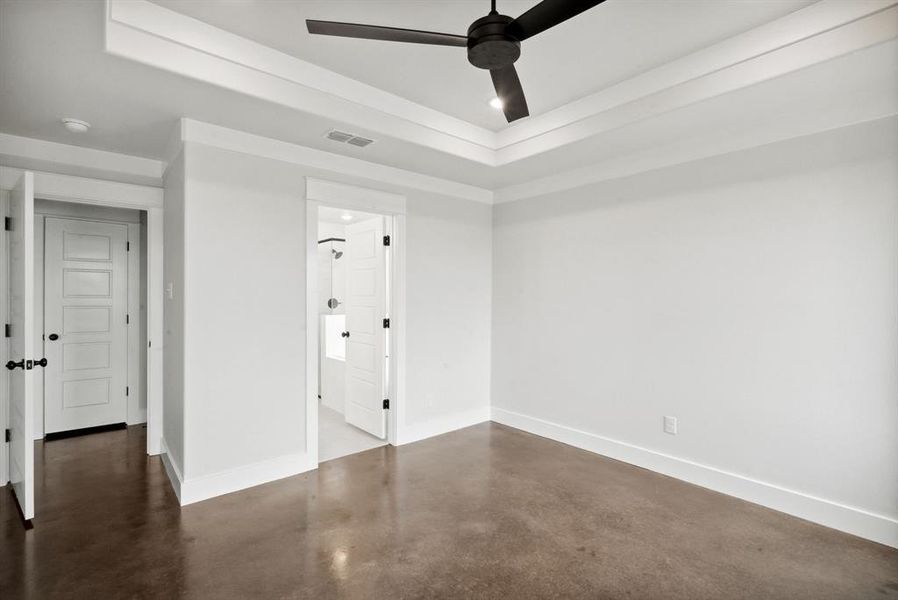 Empty room featuring concrete flooring and ceiling fan