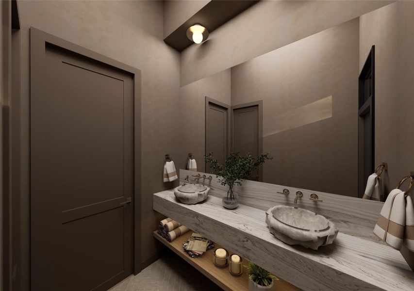 An artfully composed guest bath where organic textures and moody finishes create an intimate, high-design moment. Twin basins with warm brass fixtures and ambient lighting lend a soft, inviting glow. An artfully composed guest bath where organic textures and moody finishes create an intimate, high-design moment. Twin basins with warm brass fixtures and ambient lighting lend a soft, inviting glow.