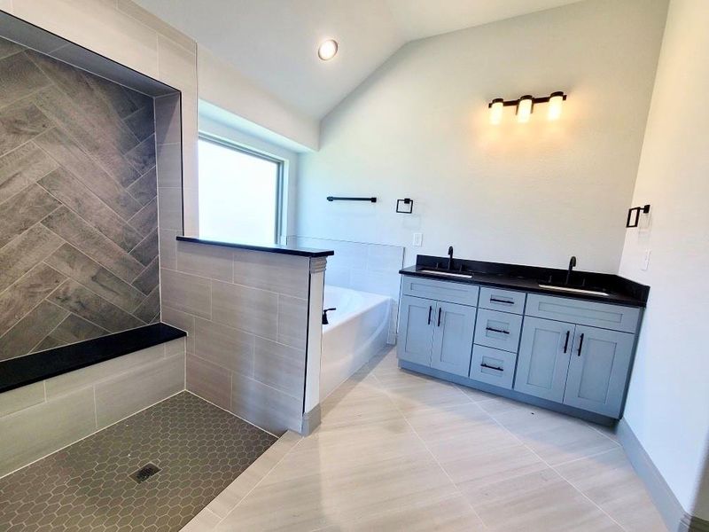 primary bathroom with double sinks, separate tub and shower. Shower glass to be installed