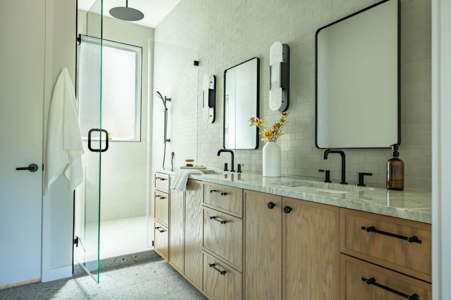 Clean lines define this modern bath with natural wood cabinetry and stone countertops. Clean lines define this modern bath with natural wood cabinetry and stone countertops.