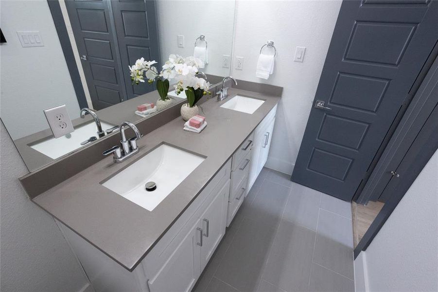 Bathroom with tile patterned flooring and vanity