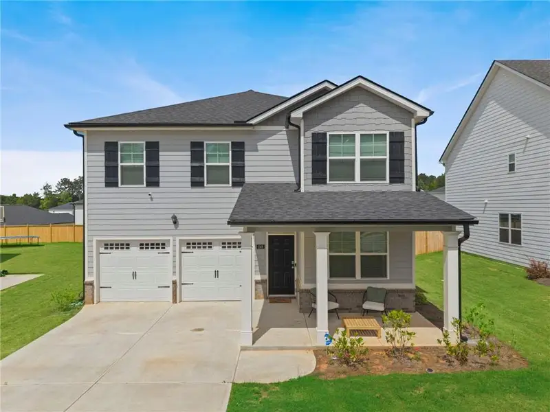Front exterior of a new home in , Hampton, GA, highlighting curb appeal (Image 1). Front exterior of a new home in , Hampton, GA, highlighting curb appeal (Image 1).
