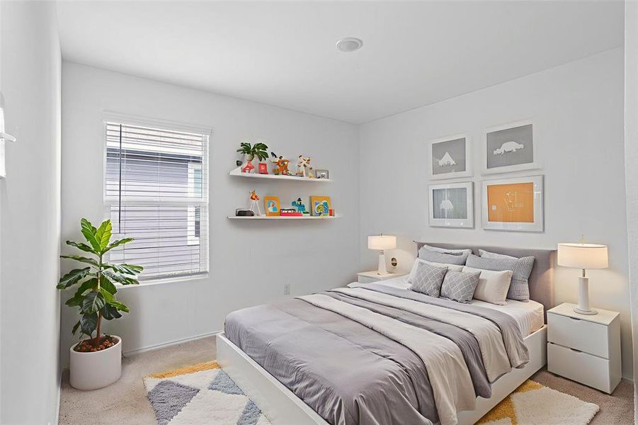 Bedroom featuring light colored carpet and baseboards