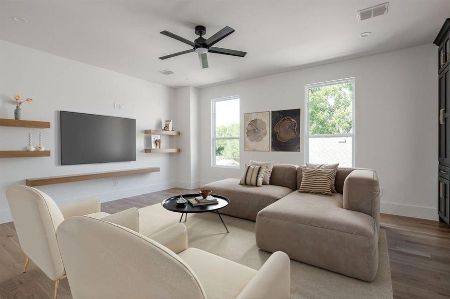 Living room with light wood-style flooring, a ceiling fan, and recessed lighting Living room with light wood-style flooring, a ceiling fan, and recessed lighting