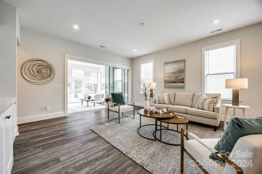 Three panel sliding door with electronic shades opens to this spacious enclosed patio area.  You will love lounging in comfort inside and out!