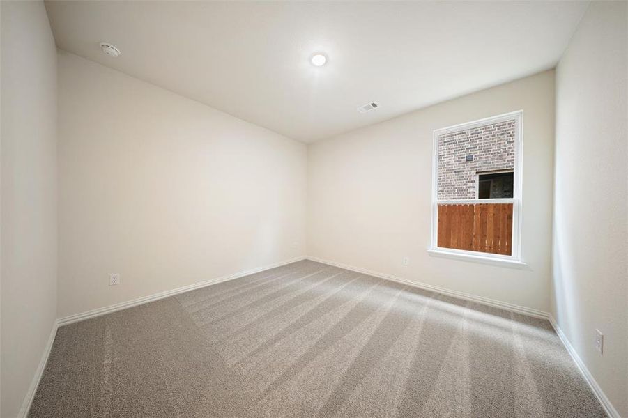 Carpeted empty room with baseboards