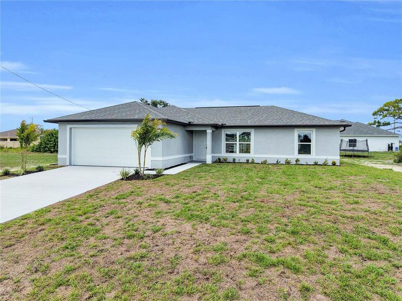 Front exterior of a new home in , Cape Coral, FL, highlighting curb appeal (Image 17).
