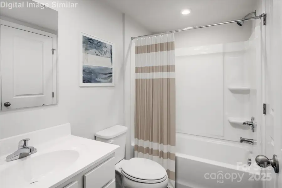 Guest-ready and full of charm! This bathroom features a relaxing tub and plenty of cabinet space — perfect for pampering or quick refreshes!