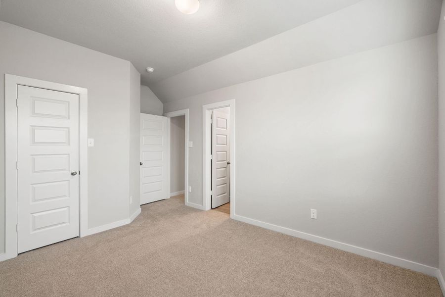 Generously sized secondary bedrooms featuring spacious closets, soft and inviting carpeting underfoot, large windows allowing plenty of natural light, and the added touch of privacy blinds for your personal retreat. Sample photo of completed home with similar floor plan. As-built interior colors and selections may vary.