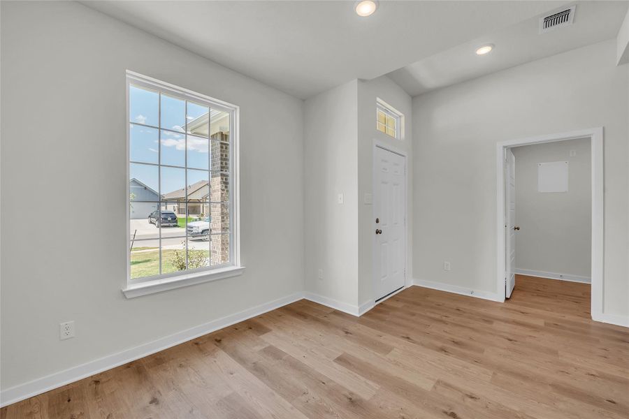 Entrance foyer with light wood-style flooring and recessed lighting Entrance foyer with light wood-style flooring and recessed lighting