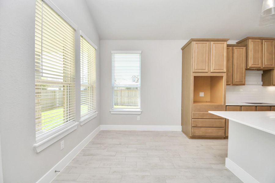 Enjoy breakfast with ease in the connected and cozy breakfast area, seamlessly integrated with the kitchen for utmost convenience. Step through the back door for a breath of fresh air onto the covered patio, extending your living space to the outdoors Enjoy breakfast with ease in the connected and cozy breakfast area, seamlessly integrated with the kitchen for utmost convenience. Step through the back door for a breath of fresh air onto the covered patio, extending your living space to the outdoors