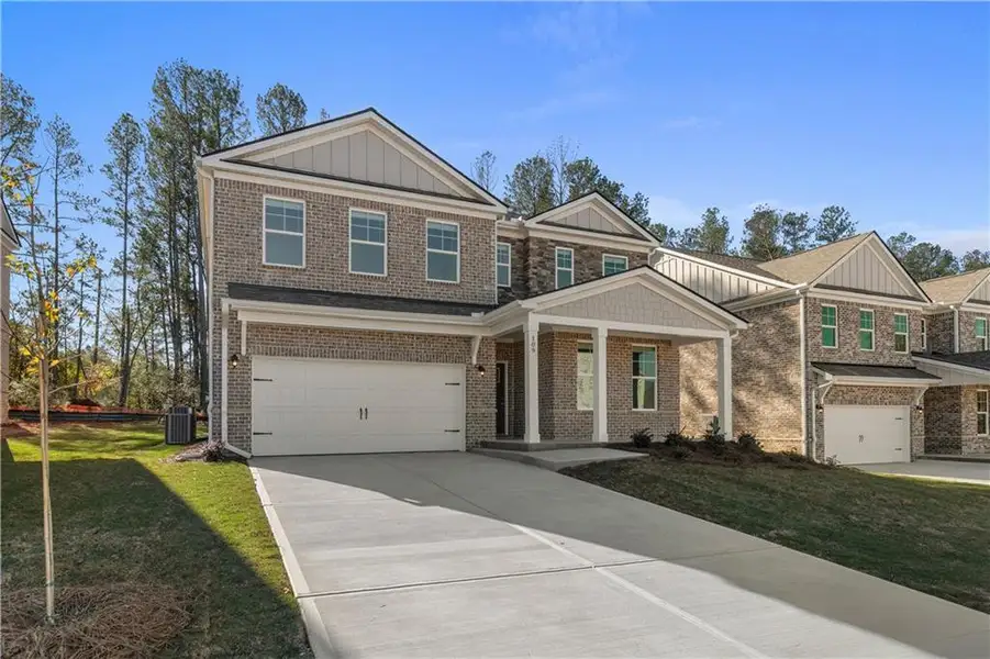 Front exterior of a new home in Bowers Farm, McDonough, GA, highlighting curb appeal (Image 1). Front exterior of a new home in Bowers Farm, McDonough, GA, highlighting curb appeal (Image 1).