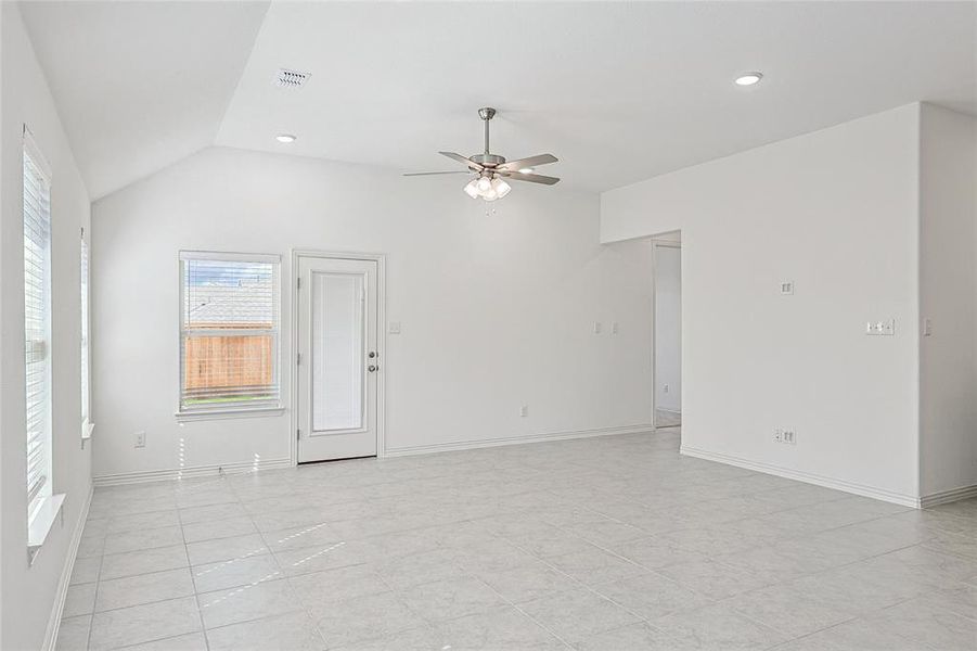 Tiled spare room featuring ceiling fan and lofted ceiling