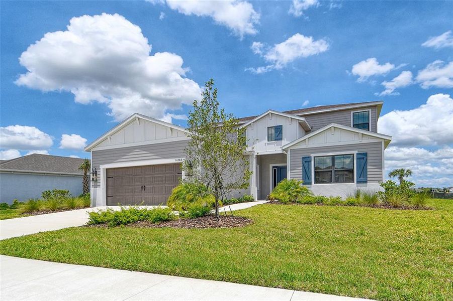 Front exterior of a new home in Canoe Creek, Parrish, FL, highlighting curb appeal (Image 26).