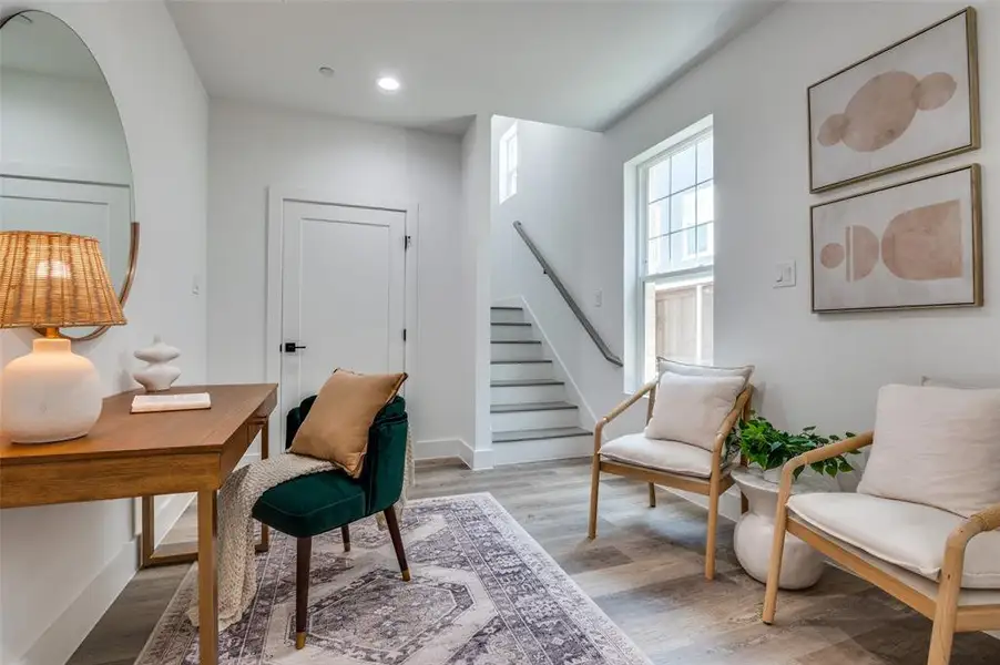 Office featuring wood finished floors, recessed lighting, and arched walkways