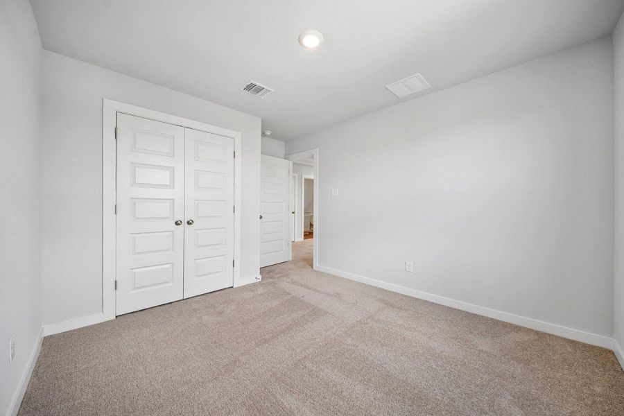 An inviting room features plush carpet and multiple doors, hinting at ample storage and connectivity. An inviting room features plush carpet and multiple doors, hinting at ample storage and connectivity.