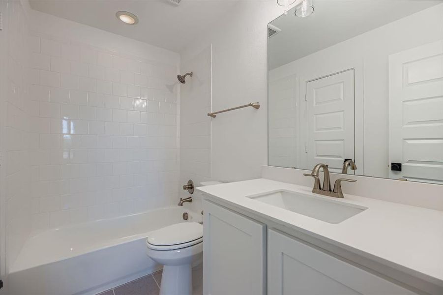 Full bath with vanity, bathtub / shower combination, and tile patterned floors