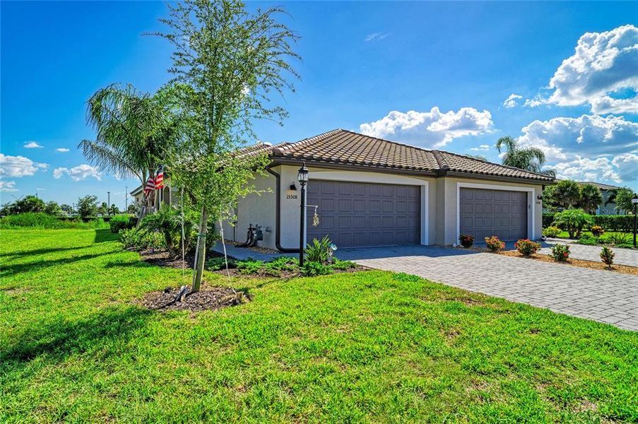 Front exterior of a new home in Lorraine Lakes at Lakewood Ranch, Lakewood Ranch, FL, highlighting curb appeal (Image 1). Front exterior of a new home in Lorraine Lakes at Lakewood Ranch, Lakewood Ranch, FL, highlighting curb appeal (Image 1).
