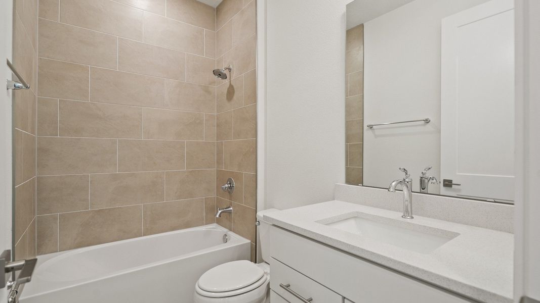 Secondary Bathroom in the Buttonwood Floor Plan by DRB Homes in Ardisia Park in New Smyrna Beach