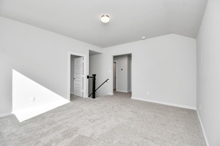 Come upstairs and enjoy a day of leisure in this fabulous game room! This is the perfect hangout spot or adult game room! Features plush carpet, high ceilings, custom paint and windows for plenty of natural light. Sample photo of completed home with similar floor plan. Actual colors and selections may vary.