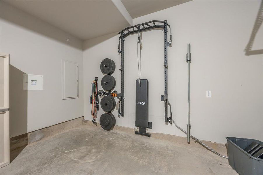 2 car garage with door opener and retractable workout weight station that can convey to the new buyer - View