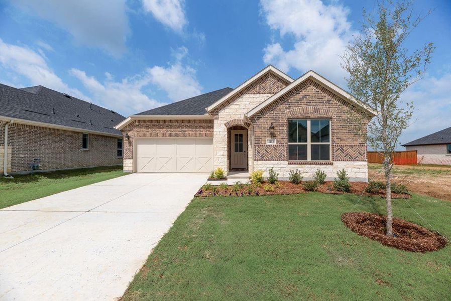 Front exterior of a new home in Spiritas Ranch, Little Elm, TX, highlighting curb appeal (Image 21).