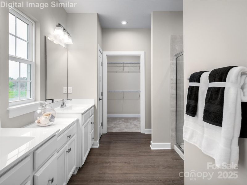Spacious and stylish — this primary bath features his-and-hers sinks, generous cabinet and counter space, and all the room you need to start and end your day in comfort. Spacious and stylish — this primary bath features his-and-hers sinks, generous cabinet and counter space, and all the room you need to start and end your day in comfort.