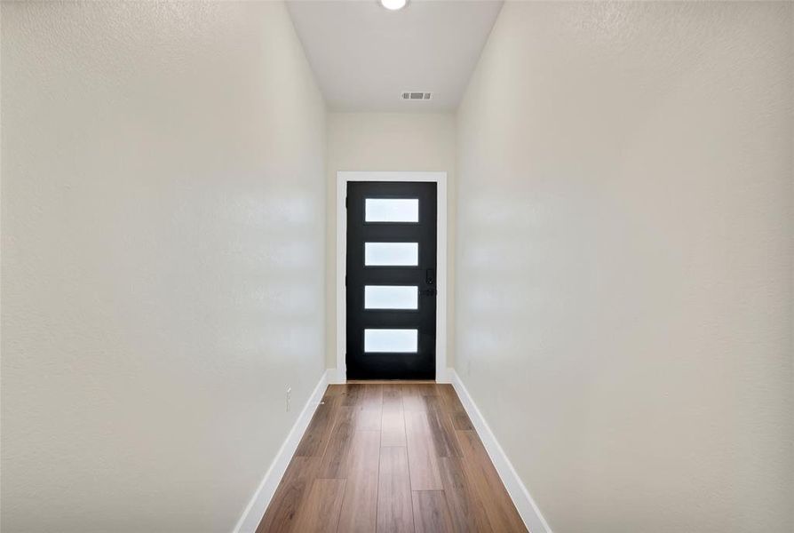 Entryway with hardwood / wood-style floors