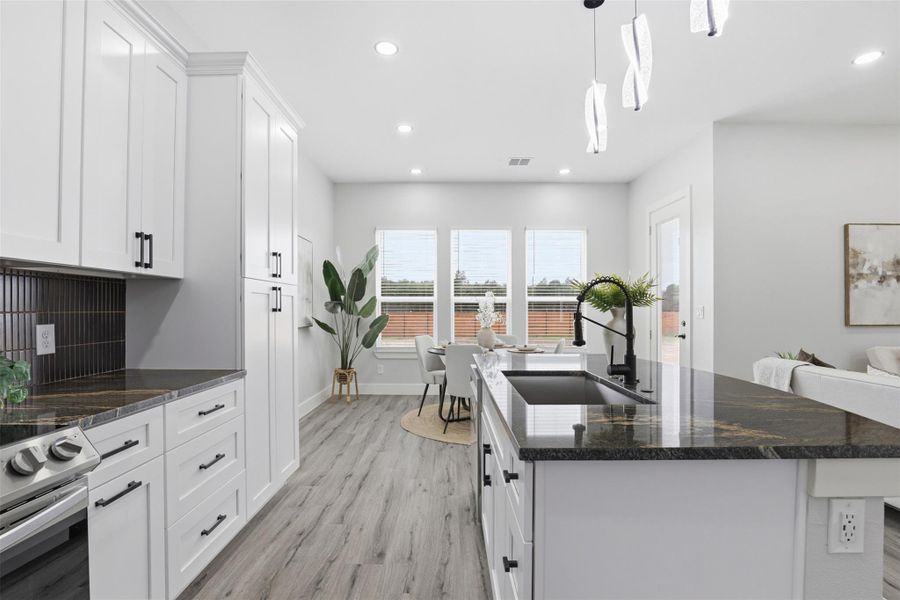 Kitchen island with dark countertop and undermount sink