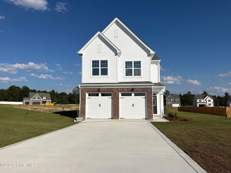 Front exterior of a new home in Sandy Springs, Aberdeen, NC, highlighting curb appeal (Image 2).