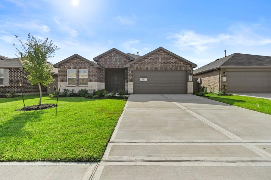 Front exterior of a new home in Harrington Trails at The Canopies, Splendora, TX, highlighting curb appeal (Image 17).