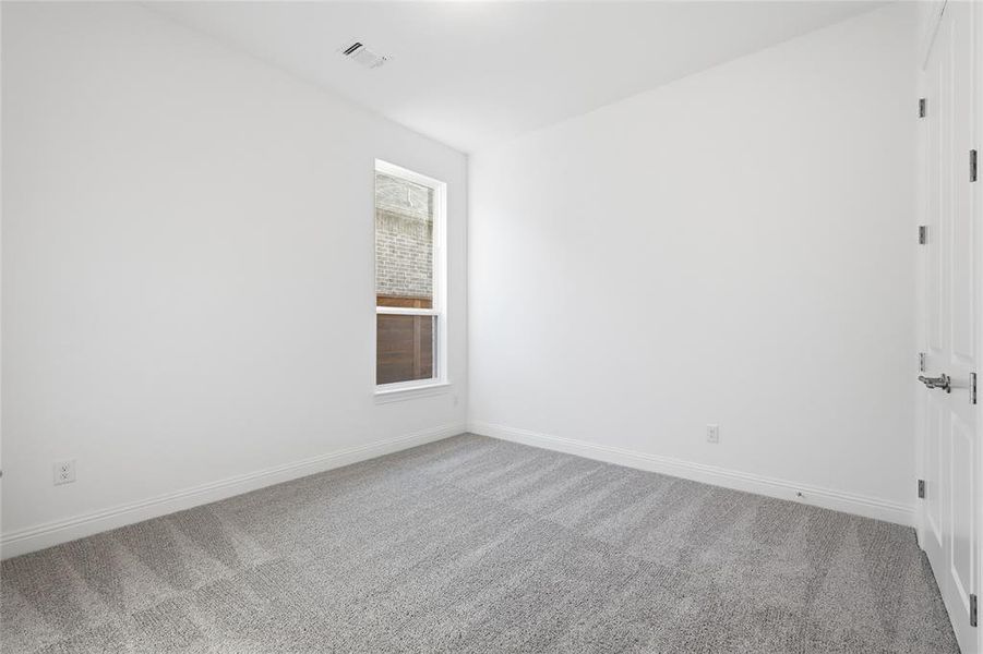 Empty room with carpet flooring and baseboards