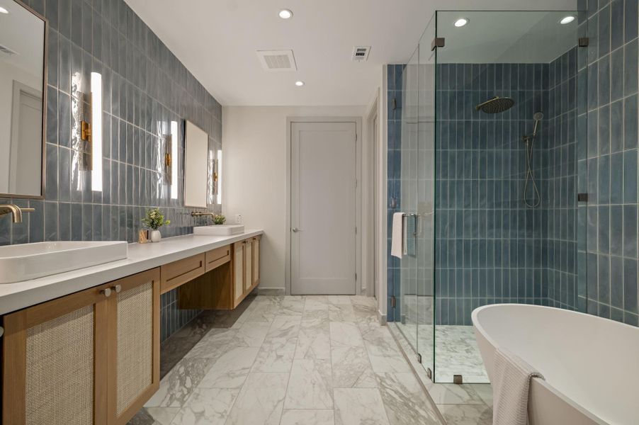 A well-appointed bath features a spacious vanity, walk-in shower, and a freestanding soaking tub.