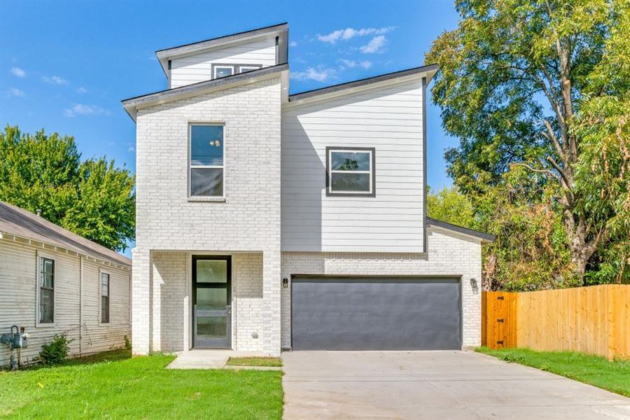 Contemporary home with a garage and a front yard